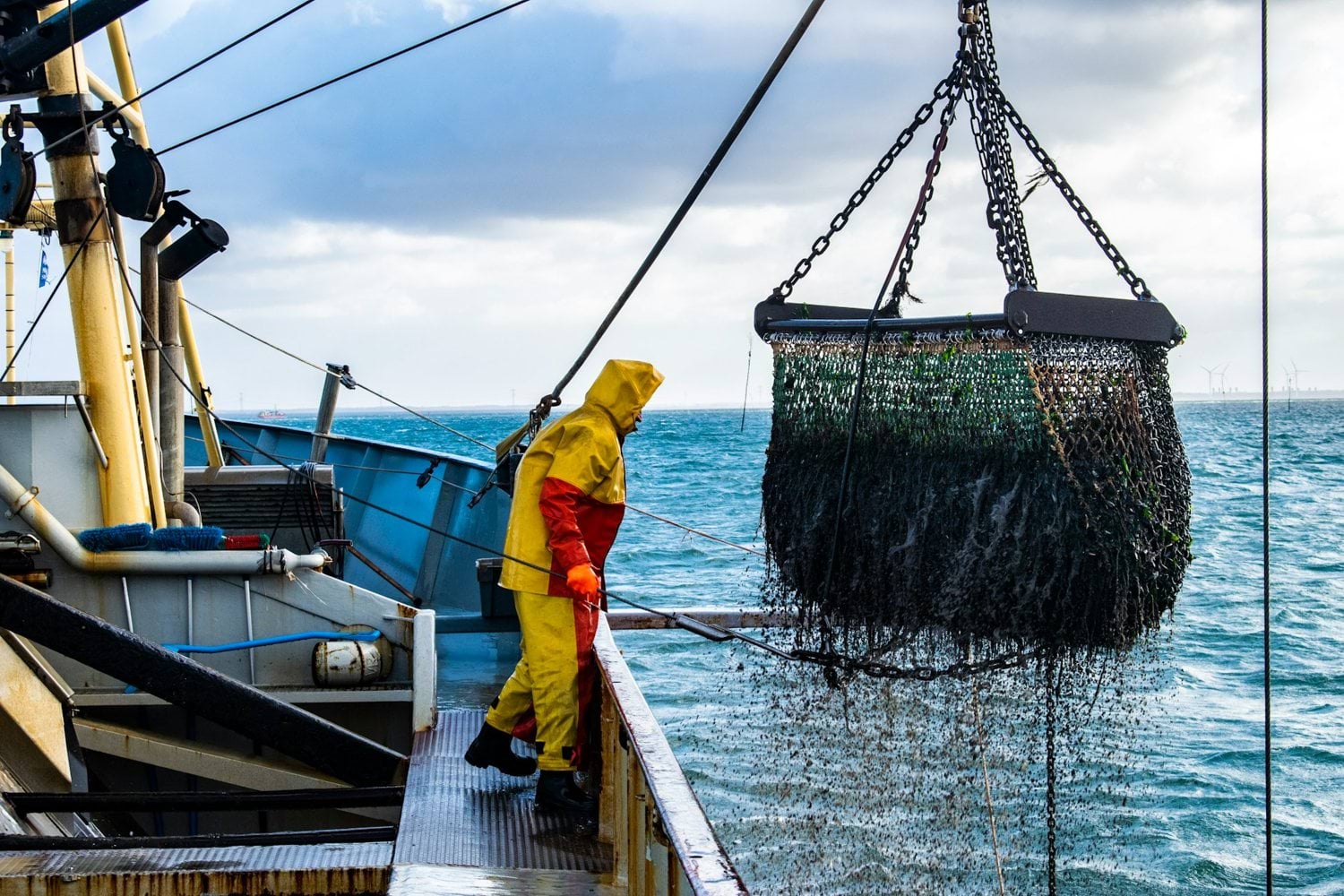 Commercial fishing vessel hauling net full of catch representing seafood production and life cycle assessment (LCA) for driving sustainable decision-making in fisheries